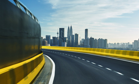 Highway overpass motion blur with city background .の写真素材