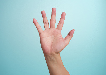 man's hand isolated on blue backgroundの写真素材