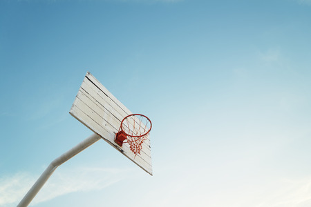 Basketball hoop on empty outdoor courtの写真素材