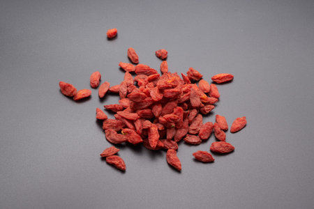 Wolfberry (Other names are Goji, goji berry) isolated on grey background