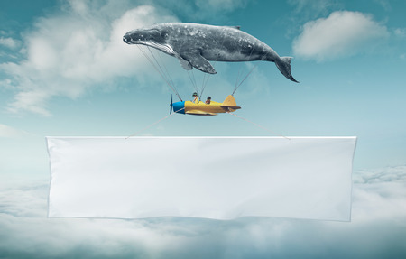Blank white banner with a copy space area hanged up from fantasy air planeの写真素材