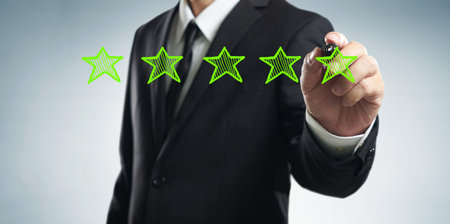 Review, increase rating, performance and classification concept. Businessman draw five green stars...