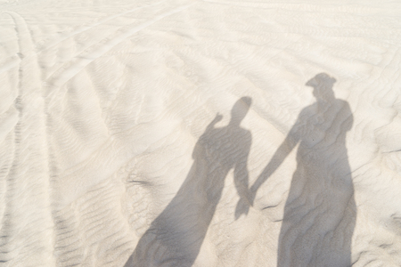 Shadow of couple on beachの写真素材
