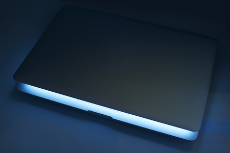 Laptop half close with white screen .Low Key lighting and close up selected focus.の写真素材