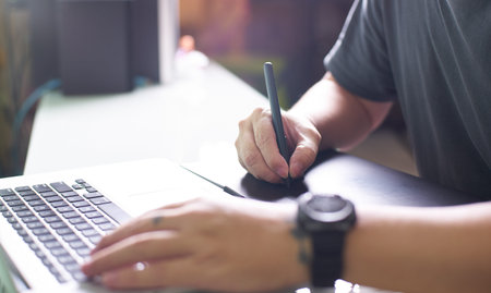 Graphic designer using digital tablet and laptop,selected focus with blurred background .の写真素材