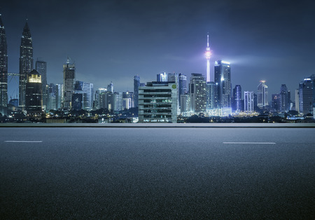 Side view asphalt road on snight scene near the modern city .の写真素材