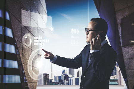 Smart businessman using the modern technologies analyst marketing and finance of business growing.の写真素材