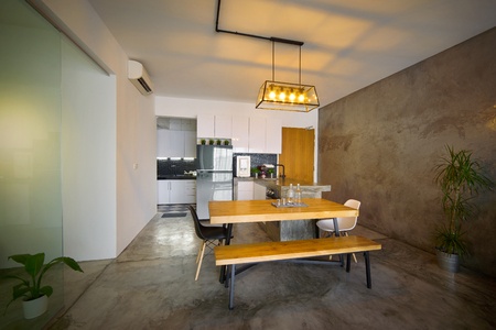Modern kitchen interior with wooden dining table in a loft style house , Interior photography.の写真素材