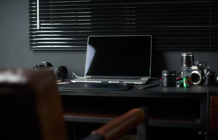 Work space on black table of a photographer or designer with laptop , retro camera , Stylish home studio concept of hipster . Seleted focus.の写真素材