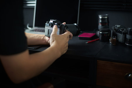 Photographer working checking camera  ,Stylish home studio concept of hipster . Seleted focus.