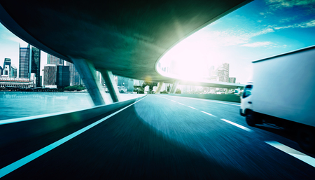 Truck traveling on road at sunrise - speed and delivery concept.の写真素材