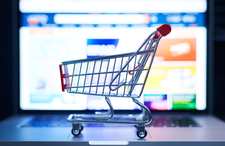 Shopping cart or trolley in front of Laptop , online marketing and business trading concept. Selected focusing .の写真素材