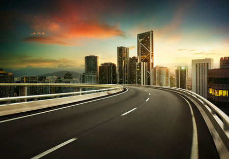 Highway overpass motion blur with city background .の写真素材