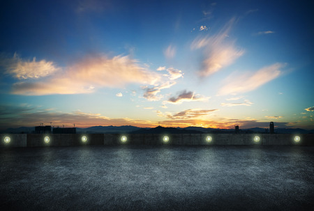Empty asphalt roof top with evening dramatic sky.の写真素材