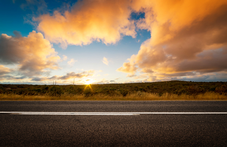 Picturesque landscape scene and sunset above roadの写真素材