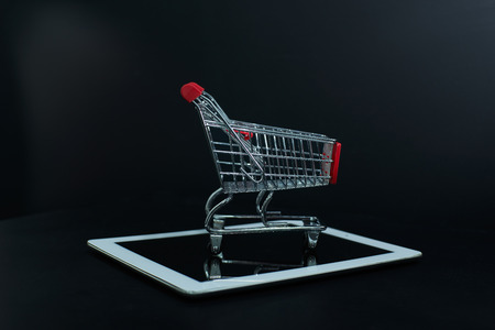 Shopping cart or trolley  on black backgroundの写真素材