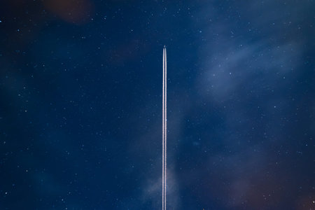 Airplane contrail against clear blue sky