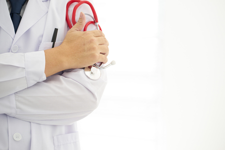Portrait an unknown young male doctor holding a stethoscope .の写真素材