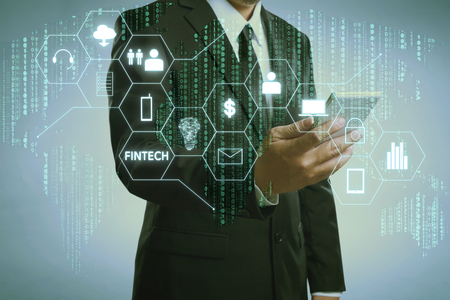 Businessman with fintech icon and internet of things with matrix code background
, Investment and financial internet technology concept.の写真素材