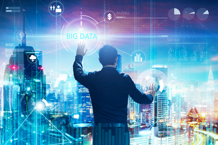 Back view of a businessman touching "BIG DATA" word on digital virtual screen with both hands. Hi-tech business concept .の写真素材