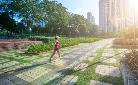 Young woman running in park at morning.の写真素材