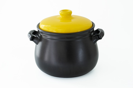 Yellow cap and black cooking pot isolated over white background .の写真素材