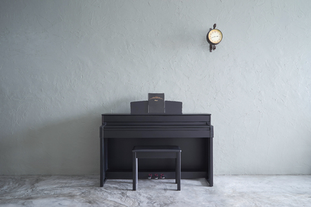 Modern living room with piano and clock . cement floor and concrete wall , Interior Interior design with Loft style .の写真素材