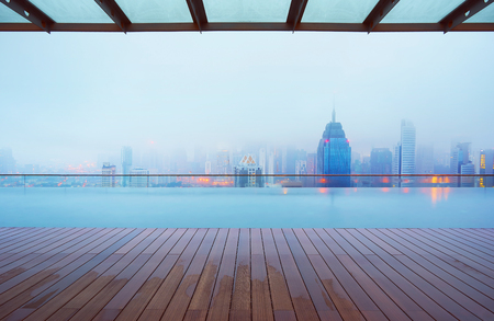 Swimming pool on roof top with beautiful city skyline view,early morning with mist ,  kuala lumpur malaysia.の写真素材