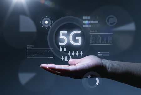 5G network wireless systems and internet of things with open palm hand gesture of male hand on dark background .の写真素材