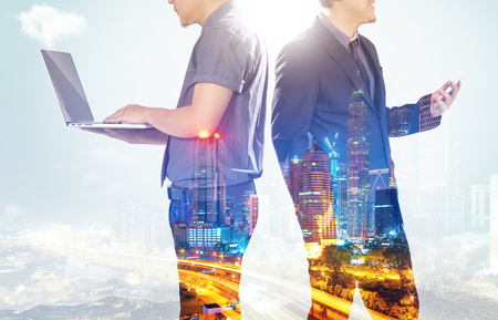 Closeup business partner team standing with night cityscape double exposure effect  .の写真素材