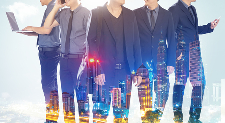 Closeup business partner team standing with night cityscape double exposure effect  .の写真素材