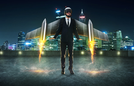 Businessman wear a rocket suit to lift , Business start up success concept . Modern city background .の写真素材