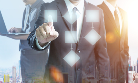 Businessman and team  process and workflow automation with flowchart , double exposure effect with cityscape  .の写真素材