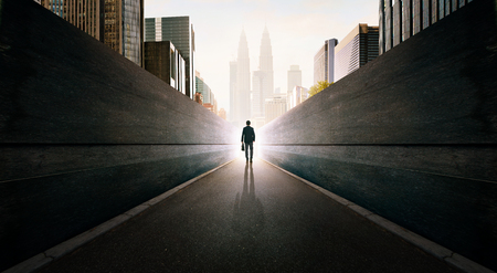 Ambitions concept with businessman walking from alley to modern city .の写真素材