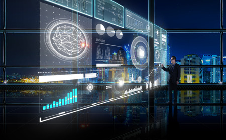 Smart financial analytics working at modern office with big data ,connections icon, internet of things, financial charts and graph virtual screen.の写真素材