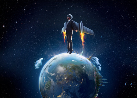 Businessman wear a rocket suit to lift from Earth planet , Business start up and travel concept .Extremely detailed imageの写真素材
