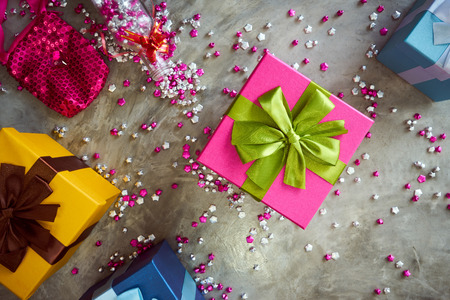 Colorful gift box with little star craft , cement texture desktop top view . Present gifts ,Christmas ,New year seasonal holiday give concept .の写真素材