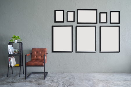 Loft style interior design  with eight empty picture frames, brown armchair and iron bookshelf .の写真素材