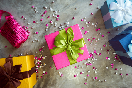 Colorful gift box with little star craft , cement texture desktop top view . Present gifts ,Christmas ,New year seasonal holiday give concept .の写真素材