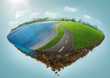 Fantasy island floating in the air with city skyline, green field, lake, mountain and curvy asphalt highway .の写真素材
