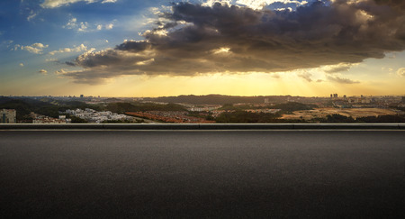 Panoramic view of asphalt road side with dramatic blue and orange color cloudy sunset golden hour .の写真素材