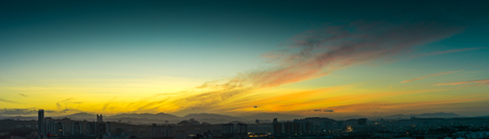 Beautiful natural sunrise  over silhouettes city skyline and amazing orange cloud blue sky above it .の写真素材