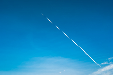 airplane contrail against clear blue skyの写真素材