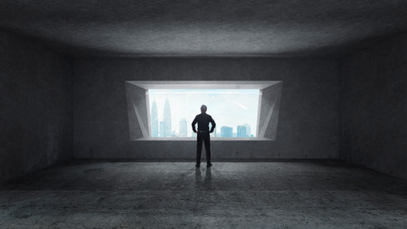 Thoughtful businessman standing in empty space concrete room with bright window and cityscape view . Mixed media .の写真素材