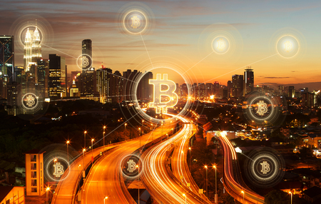 Bitcoins and blockchain network connection with night city background .Electronic money ,blockchain transfers and finance concept.の写真素材