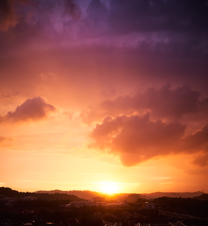 Dramatic orange and purple sunset sky . Vertical format .の写真素材