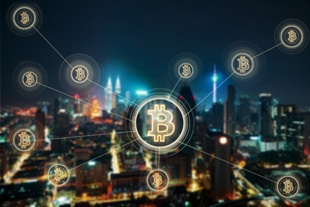 Bitcoins and blockchain network connection with blur night city background .Electronic money ,blockchain transfers and finance concept.の写真素材