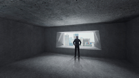 Thoughtful businessman standing in empty space concrete room with bright window and cityscape view . Mixed media .の写真素材