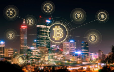 Bitcoins and blockchain network connection with blur Perth night city background .Electronic money ,blockchain transfers and finance concept.の写真素材