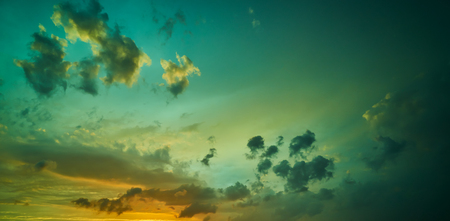 Dramatic green and yellow sunset sky . Horizontal format .の写真素材